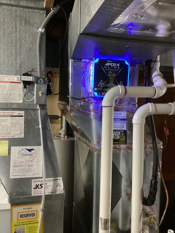 Successfully installed APCO-X ULTRA UV light system in customer's HVAC air handler to improve indoor air quality by eliminating airborne contaminants. System was properly mounted within ductwork with all electrical connections secured and tested for proper operation, confirming the distinctive UV illumination was functioning as designed.
