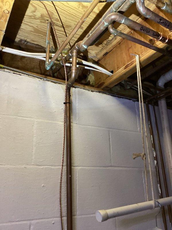 Inspected exterior spigot relocation requirements and existing plumbing infrastructure. Assessed feasibility of disconnecting old outdoor faucet and installing new frost-free fixture. Evaluated optimal pathway for running 3/4" copper pipe vertically through subfloor into kitchen cabinet and out through exterior wall, ensuring proper connections and weather resistance.