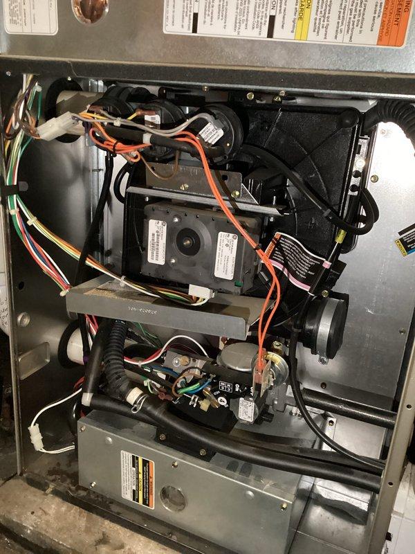 Responded to no-heat call for one of two furnaces in the residence. Upon inspection, diagnosed a plugged condensate drain line which was causing unit to surge. Successfully cleared the blockage, restoring normal operation to the affected furnace.