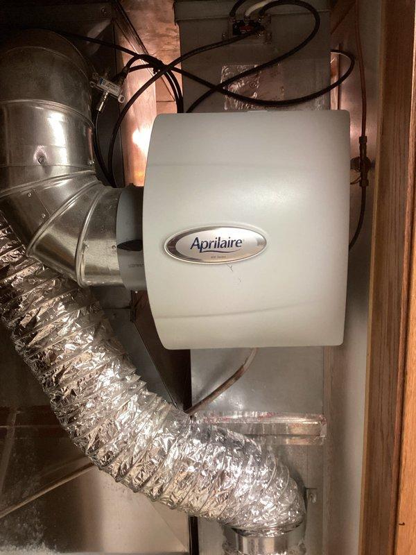 Responded to customer call for leaking Aprilaire humidifier. Conducted thorough inspection of the unit and associated components but was unable to recreate reported leak. System was functioning normally at time of service with no visible issues. Humidity control panel showing 19% relative humidity.