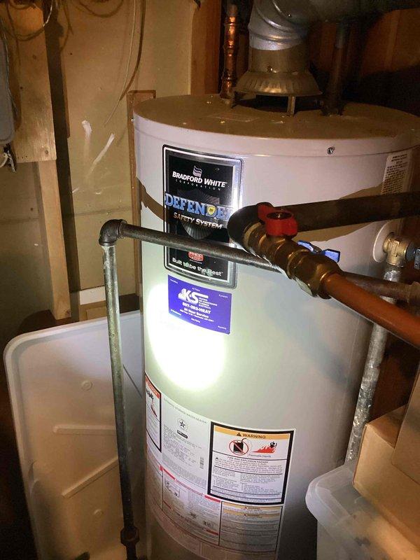 Responded to service call for Bradford White water heater with insufficient hot water. Diagnosed dirty burner assembly and flame sensor. Removed burner assembly, performed thorough cleaning of components, and verified proper operation by testing hot water flow. System now functioning correctly with proper heating capability.