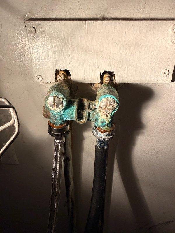 Responded to service call for leaking washing machine connection. Upon inspection, found severely corroded laundry water valves that were no longer functioning properly (not opening or closing). Removed the old deteriorated valves and installed two new water supply valves for the washing machine connections.