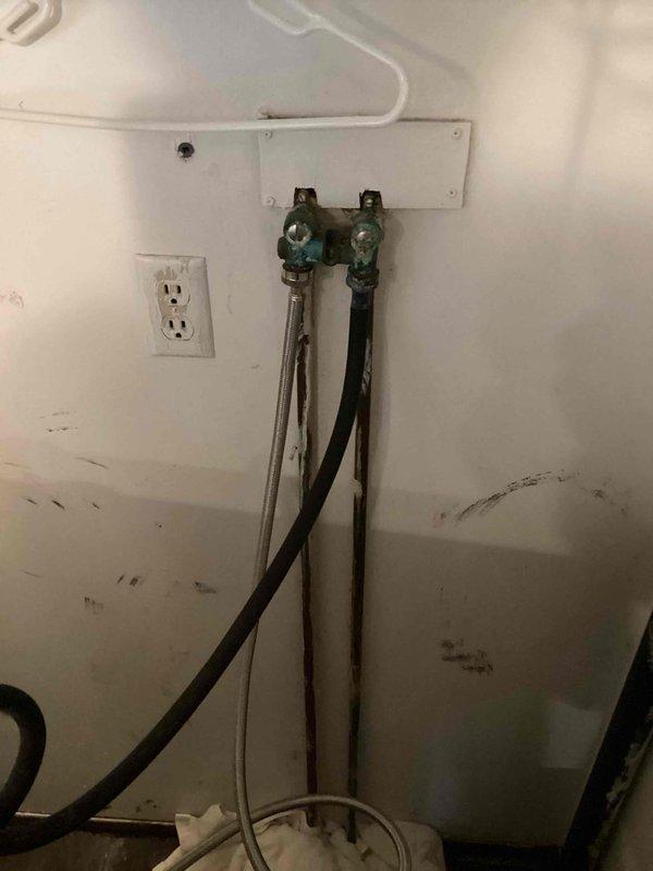 Responded to service call for leaking washing machine connection. Upon inspection, found severely corroded laundry water valves that were no longer functioning properly (not opening or closing). Removed the old deteriorated valves and installed two new water supply valves for the washing machine connections.