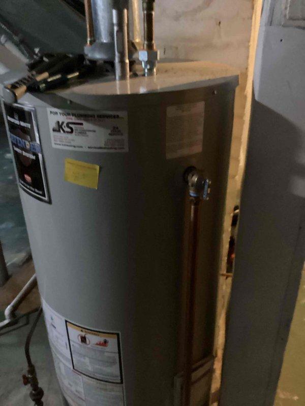 Replaced defective T&P (temperature and pressure relief) valve on JKS water heater that was actively leaking. Removed old valve and installed new replacement valve under existing warranty coverage. System now functioning properly with no leaks observed.