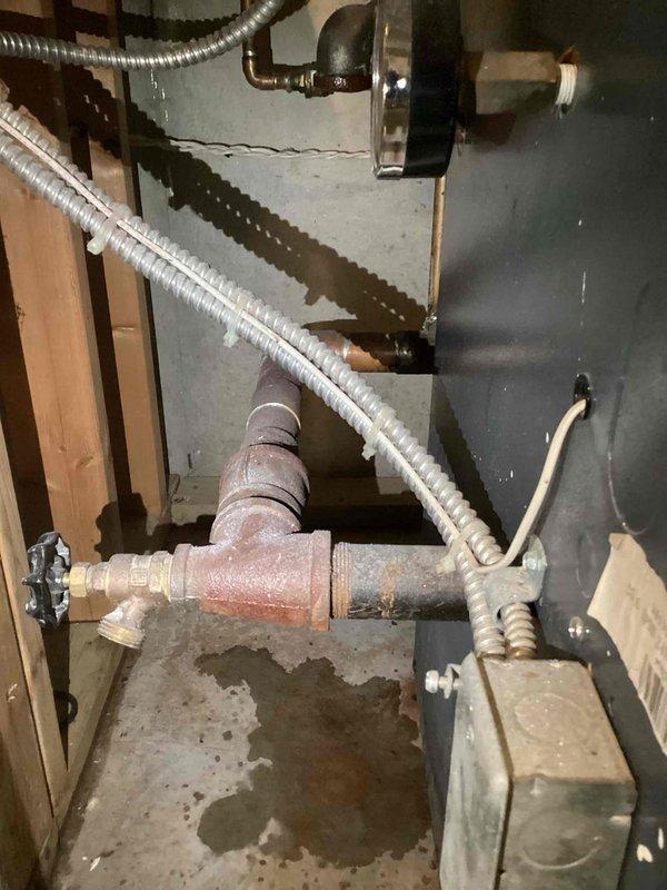 Responded to no heat complaint from boiler system. Inspection revealed low water level causing heating failure. Observed corrosion on pipes and pressure gauge readings below normal operating parameters. Added water to restore proper system pressure and verified heat function before completing service.