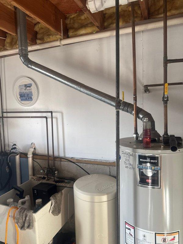 Responded to service call for no hot water. Diagnosed Bradford White water heater with ignition failure. Inspection revealed internal tank leak with visible cracking. Due to safety concerns and presence of small child, recommended complete unit replacement. Provided customer with replacement options.