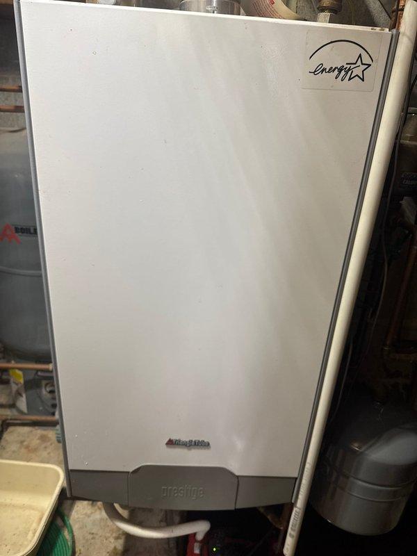 Responded to service call for Ariston Prestige boiler unexpectedly filling and leaking. Diagnostic inspection revealed waterlogged expansion tank causing system pressure issues and leakage. Successfully replaced expansion tank to restore proper system operation and prevent further water damage.