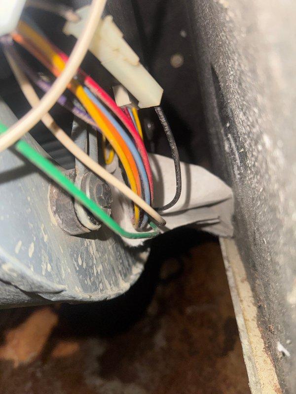 Responded to service call for furnace noise complaint. Diagnostic inspection revealed blower motor failure caused by filter being pulled into blower motor assembly, resulting in bent motor shaft. Observed extensive rust development on secondary heat exchanger. Documented electrical connection integrity and corrosion issues with photos. Recommended complete system evaluation for repair options or potential replacement.