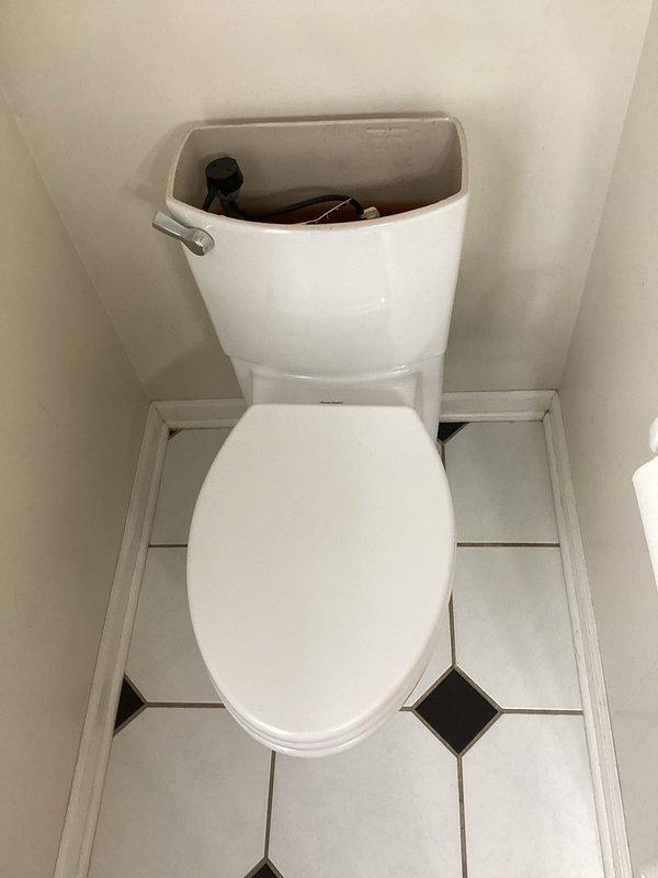 Responded to service call for ceiling leak originating from main floor toilet. Diagnosed issue as failed wax seal combined with broken toilet flange causing water damage and green corrosion on copper piping. Removed toilet, installed new repair flange, wax seal, toilet bolts and fill valve, then reset toilet and verified proper operation with no further leakage.