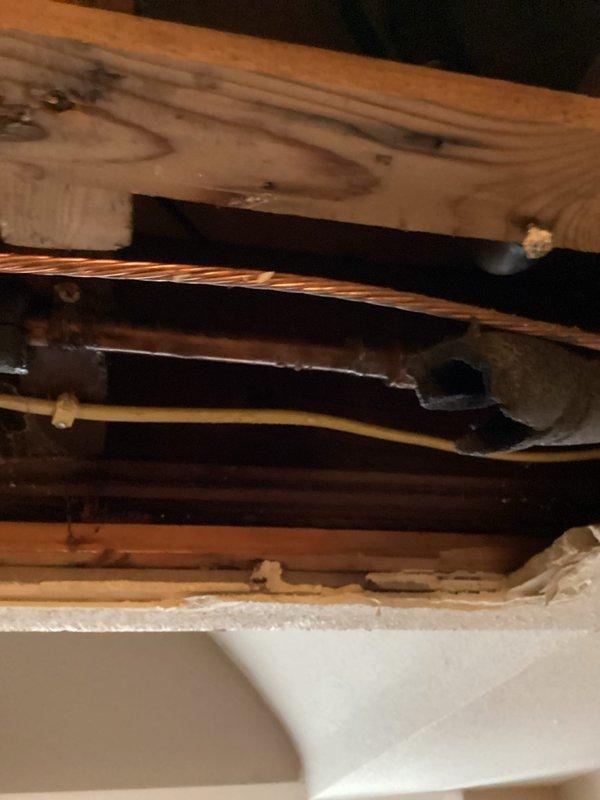 Located and repaired a pinhole leak in copper water line. Accessed the affected pipe through existing structural openings, cut out the damaged section, and installed new copper pipe. Restored water service and verified complete resolution with no further leakage.
