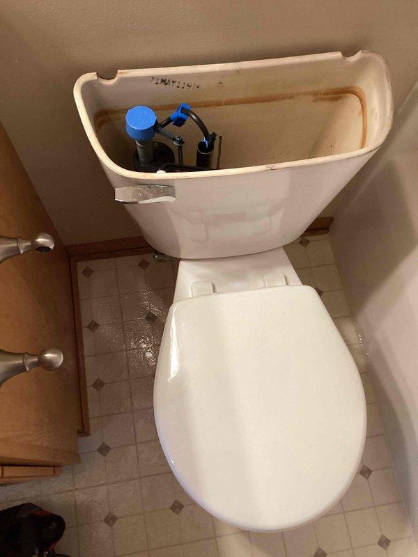 Responded to a service call regarding a water leak in kitchen wall. Upon inspection, discovered toilet with bad wax seal and loose toilet bolts causing seepage through ceiling below. Removed toilet, installed new wax seal and toilet bolts, then reset toilet. Performed multiple flush tests to confirm proper installation and verified no further leaks.