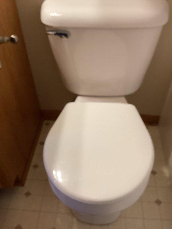 Responded to a service call regarding a water leak in kitchen wall. Upon inspection, discovered toilet with bad wax seal and loose toilet bolts causing seepage through ceiling below. Removed toilet, installed new wax seal and toilet bolts, then reset toilet. Performed multiple flush tests to confirm proper installation and verified no further leaks.