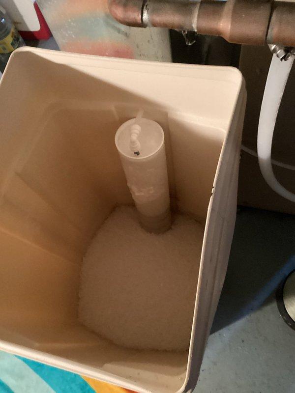 Responded to service call for non-functioning water softener. Diagnosed intermittent power issues caused by faulty outlet/light fixture connection that was causing excessive regeneration cycles. Installed new drain line on softener, replenished brine tank with two bags of salt, and verified proper operation by running a complete regeneration cycle.