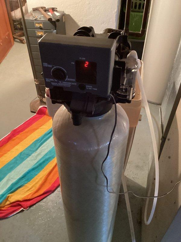 Responded to service call for non-functioning water softener. Diagnosed intermittent power issues caused by faulty outlet/light fixture connection that was causing excessive regeneration cycles. Installed new drain line on softener, replenished brine tank with two bags of salt, and verified proper operation by running a complete regeneration cycle.