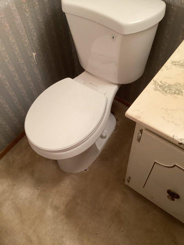 Arrived in afternoon as requested to install new toilet in half bathroom. Removed existing unit and installed new toilet with fresh wax seal and toilet bolts. Noted carpeted flooring with improperly squared flange and absence of subfloor during installation. Tested functionality by filling and flushing multiple times, confirming proper operation.