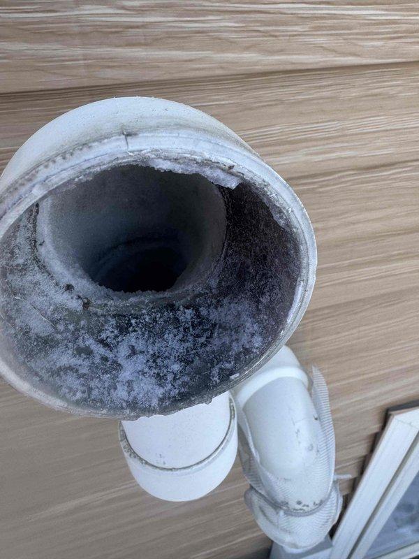Responded to no heat complaint on Amana furnace. Diagnosed frozen exhaust and intake caused by unauthorized metal screens installed over terminations. Removed screens and cleared ice buildup, restoring proper combustion air and exhaust flow. Noted significant mold growth in condensate drain system requiring future attention.