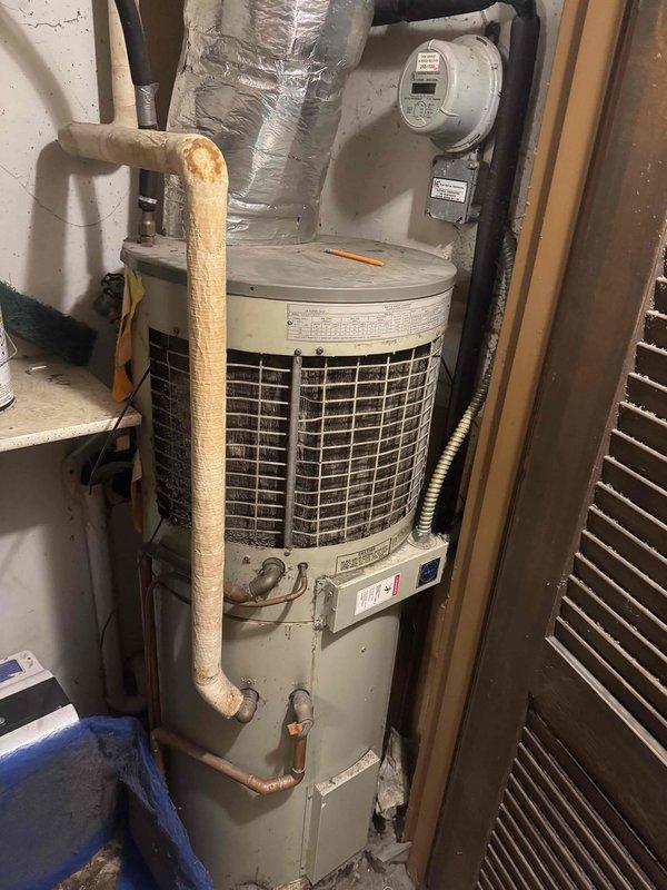 Responded to no heat call for a heat pump system with air handler/water heater combination. Diagnosed system blowing cold air due to severely clogged filter restricting proper airflow. Inspected aging unit which showed signs of wear on insulated piping and connections. Completed preventive maintenance and discussed replacement options with customer.