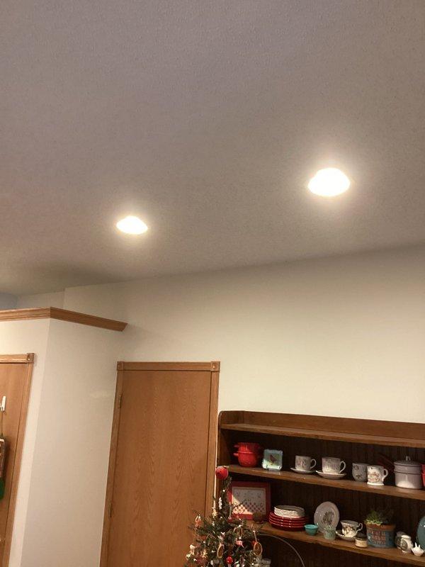 Responded to service call regarding flickering light fixture above stove. Diagnosed issue as combination of loose bulbs and overheating due to high wattage bulbs in recessed can lights. Replaced with appropriate lower wattage bulbs to prevent future overheating and ensure proper fixture operation.