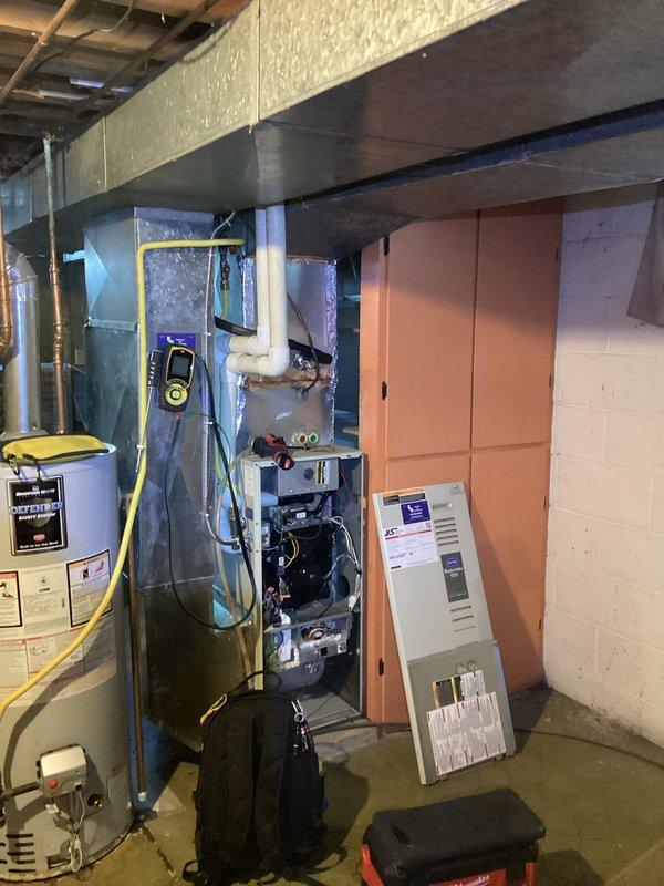 Responded to emergency no-heat call to find furnace blowing cold air with indoor temperature at 49°F. Upon inspection, determined heat exchanger had failed in aging system (10+ years old). Diagnosed issue, documented condition with photos of both outdoor unit and furnace with exposed components, and connected customer with project manager to discuss replacement options.