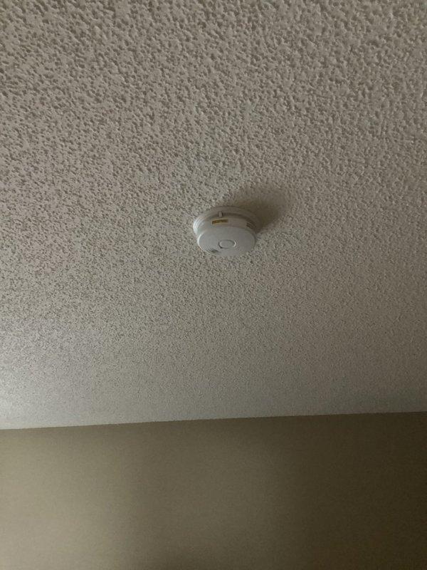 Responded to service call for hard-wired smoke alarm that activated twice. Inspected unit and confirmed power supply was functioning properly. Determined green blinking LED indicated normal operation following previous alarm event. Advised customer that replacement was not necessary as detector was operating as designed.