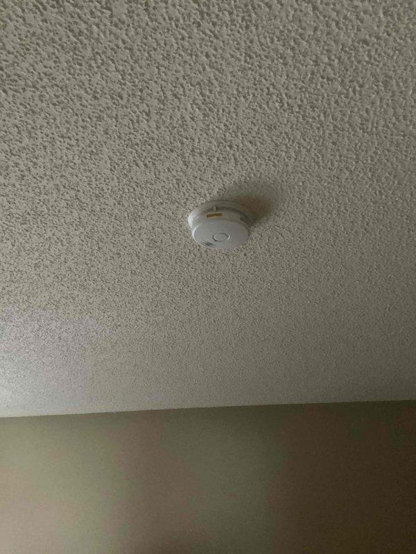 Responded to service call for hard-wired smoke alarm that activated twice. Inspected unit and confirmed power supply was functioning properly. Determined green blinking LED indicated normal operation following previous alarm event. Advised customer that replacement was not necessary as detector was operating as designed.