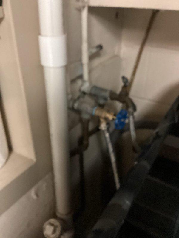 Responded to customer complaint of low water pressure, specifically affecting the hot water side of laundry water line. Diagnosed corroded laundry valve and deteriorated black washing machine hose as the source of restriction. Replaced both components with new valve and hose, restoring proper water flow and pressure to the washing machine.