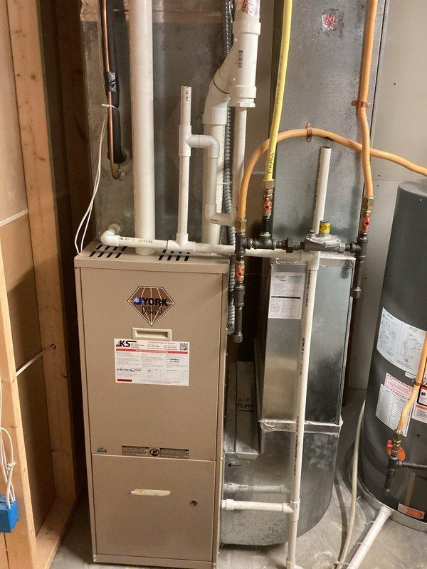 Responded to no heat call for 10+ year old York furnace. Diagnosed failed inducer motor causing extremely loud noise and heating failure. Replaced inducer motor assembly to restore proper system operation and heating function.