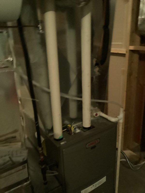 Performed scheduled tune-up service on Lennox furnace system located in utility room. Conducted comprehensive inspection of all components including air handler, ventilation, and drainage systems. All connections and PVC piping were verified to be properly installed and functioning correctly with no issues identified.