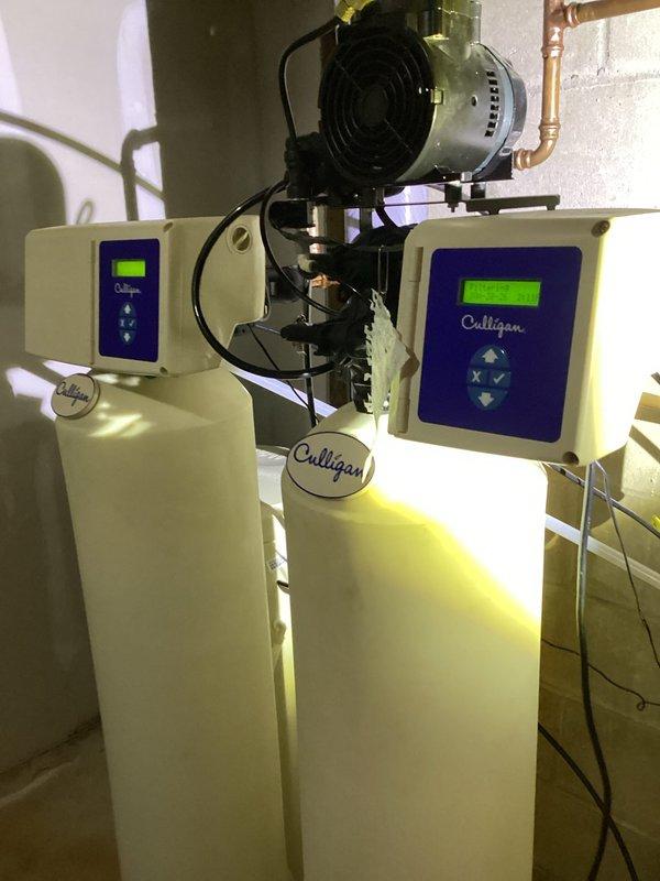 Responded to a service call regarding severely low water pressure throughout the residence. Diagnostic testing revealed good water pressure in the basement up to the whole house filtration system, but significant pressure drop after the Culligan brand softener. Visual inspection confirmed the whole house filter requires cleaning or replacement, and the iron filter and softener need professional servicing. Advised customer to contact Culligan directly to service their filtration system components to restore proper water pressure to the home.