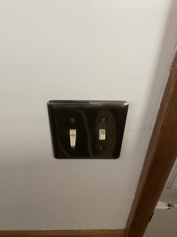 Responded to service call for non-functioning exterior outlet and faulty light switch. Inspection revealed damaged outlet with scorch marks and insufficient mounting to tin siding. Replaced defective outlet, installed proper outdoor protective cover, and replaced malfunctioning 3-way switch to restore full functionality to both electrical components.