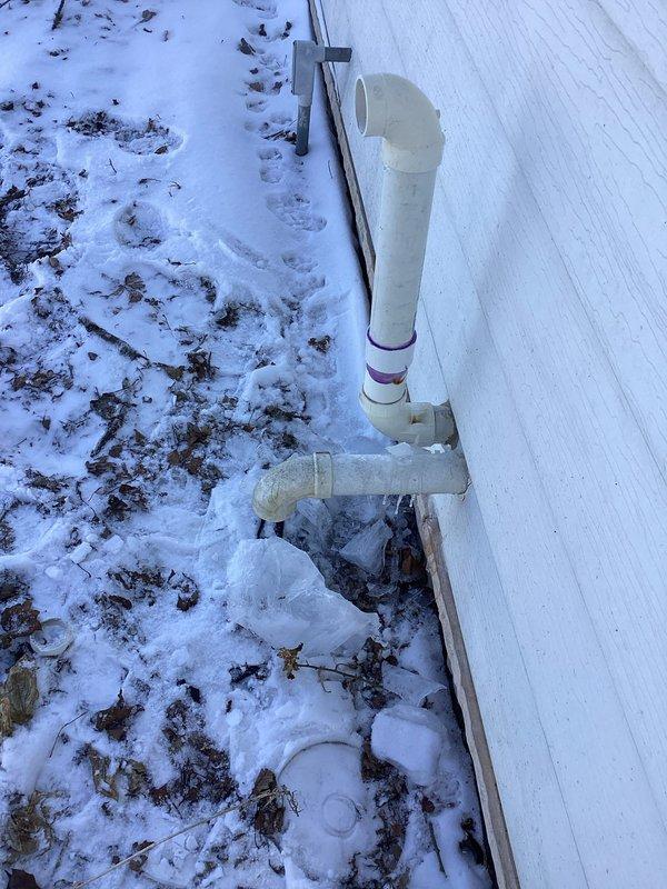 Responded to service call for detached exhaust pipe. Diagnosed broken PVC exhaust/vent piping at exterior wall. Successfully replaced damaged PVC components and restored proper venting system functionality.