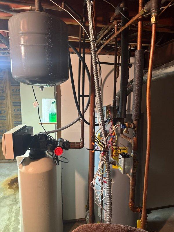 Responded to emergency no-heat call and discovered water leak from 1/2" copper line spraying directly onto boiler components. Patched damaged pipe section and thoroughly dried cabinet interior and flame sensor. System restored to normal operation after resolving both the water intrusion and heating failure.