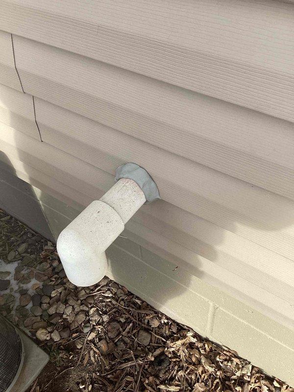 Applied thumb gum sealant around HVAC vent piping where it exits through the exterior vinyl siding to prevent water infiltration and ensure proper system ventilation.