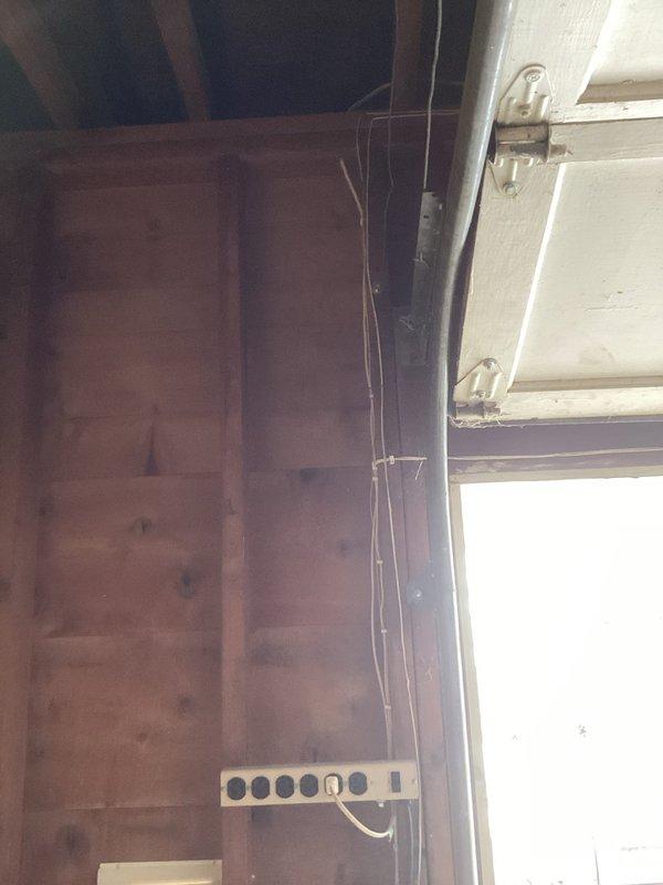 Conducted electrical inspection of residential garage, focusing on exposed wiring configuration and outlet strip installation on wooden panel walls. Examined ceiling-mounted light fixture and evaluated current electrical components for code compliance. Client requested estimates for recommended electrical upgrades.