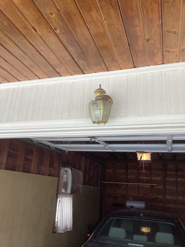 Conducted electrical inspection of residential garage, focusing on exposed wiring configuration and outlet strip installation on wooden panel walls. Examined ceiling-mounted light fixture and evaluated current electrical components for code compliance. Client requested estimates for recommended electrical upgrades.
