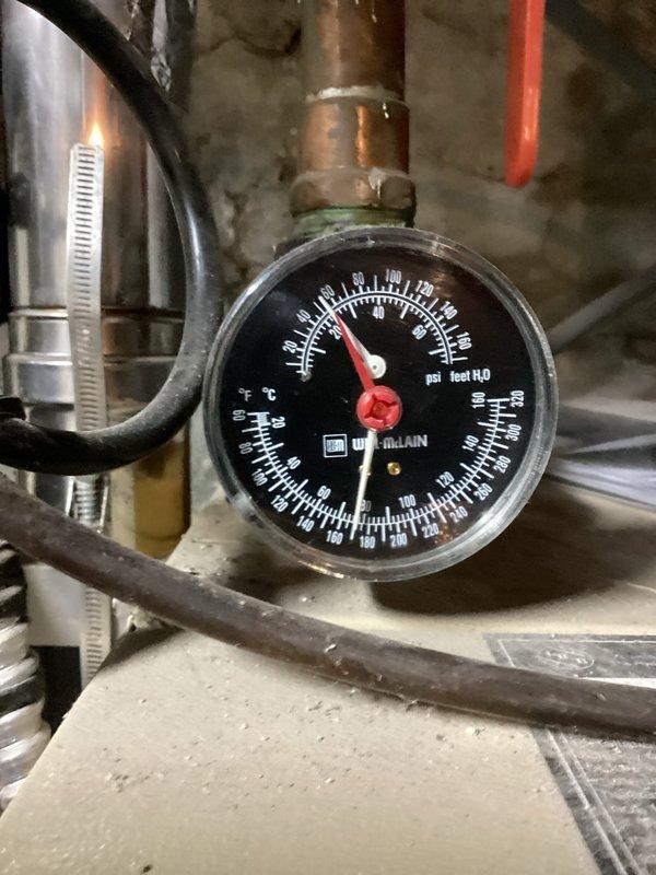 Responded to no heat complaint in home with 11 radiators. Diagnosed low water pressure and air in system causing 2 radiators (master bedroom and bath) to malfunction. Serviced Weil-McLain boiler by draining and refilling system, then bled radiators to restore proper heating function throughout the home.