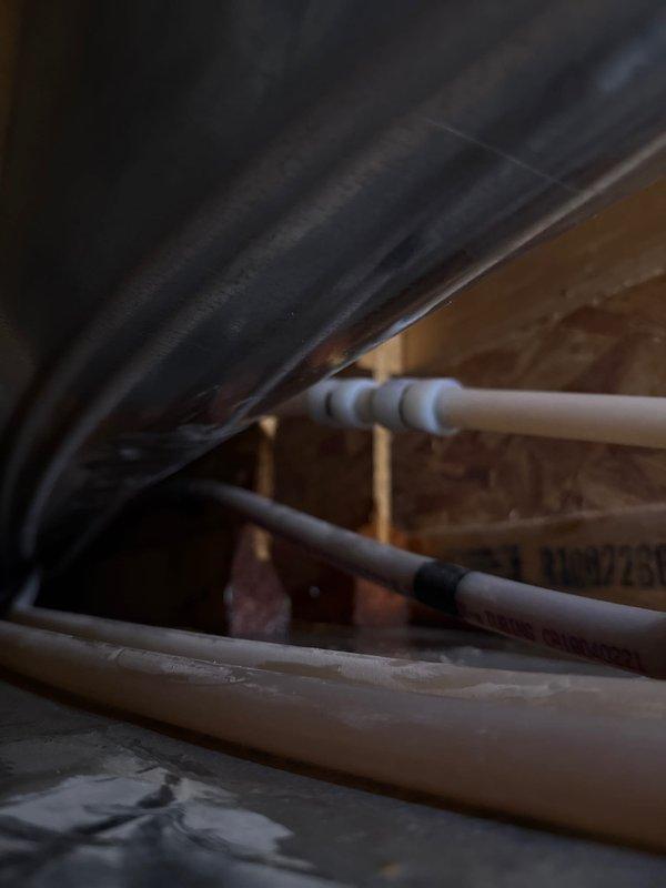 Repaired a pinhole leak in 1/2" PEX water line located above furnace trunk. Removed ductwork to access the leak, then replaced small section of PEX tubing. Completed service with proper sealing of access points.