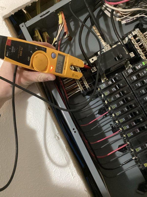 Responded to service call for power loss affecting multiple kitchen outlets, upstairs bathroom/office circuits, and furnace. Diagnostic testing with multimeter revealed complete loss of one electrical phase on utility side of connection. Contacted Rochester Public Utilities (RPU) to report outage and remained on site to verify restoration of service.