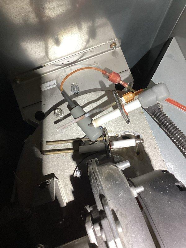 Responded to service call for heating system malfunction. Diagnosed faulty ignitor and successfully installed replacement component. System tested after repair with all parameters functioning normally - control panel showing proper flame operation (100%) and appropriate temperature readings across the system (inlet: 39°F, outlet: 99°F).