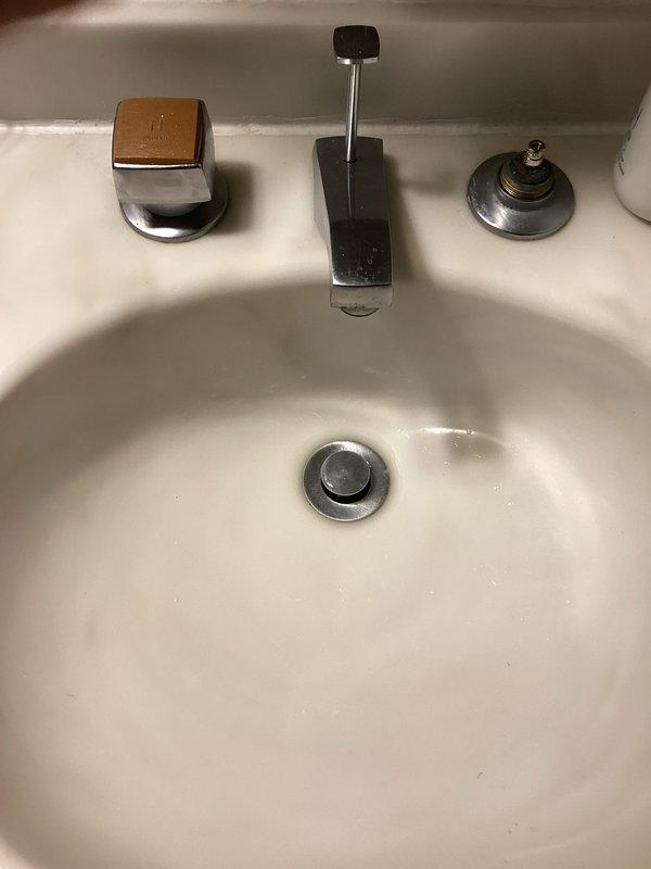 Diagnosed and inspected master bathroom plumbing issues, finding a leaking Kohler shower valve behind the handle and a seized right-side control on the three-piece laboratory faucet. Provided estimate for replacement of shower valve and documented condition with photos.