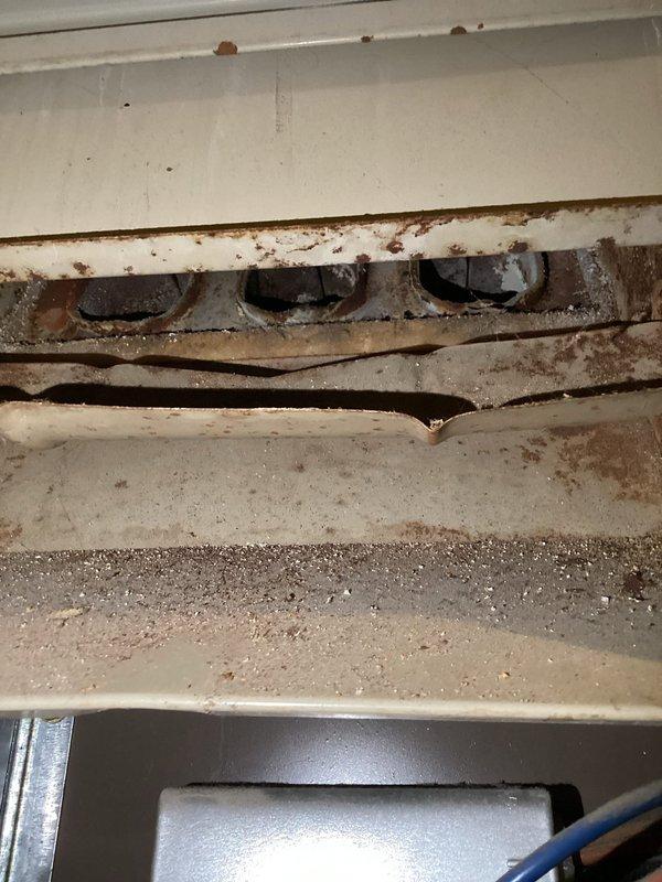 Performed a comprehensive air handler tune-up with inspection revealing significant dust and debris accumulation in the burner assembly and ports. Noted corrosion on interior metal components and confirmed proper valve operation on the supply line. System was cleaned and serviced to restore optimal operation.