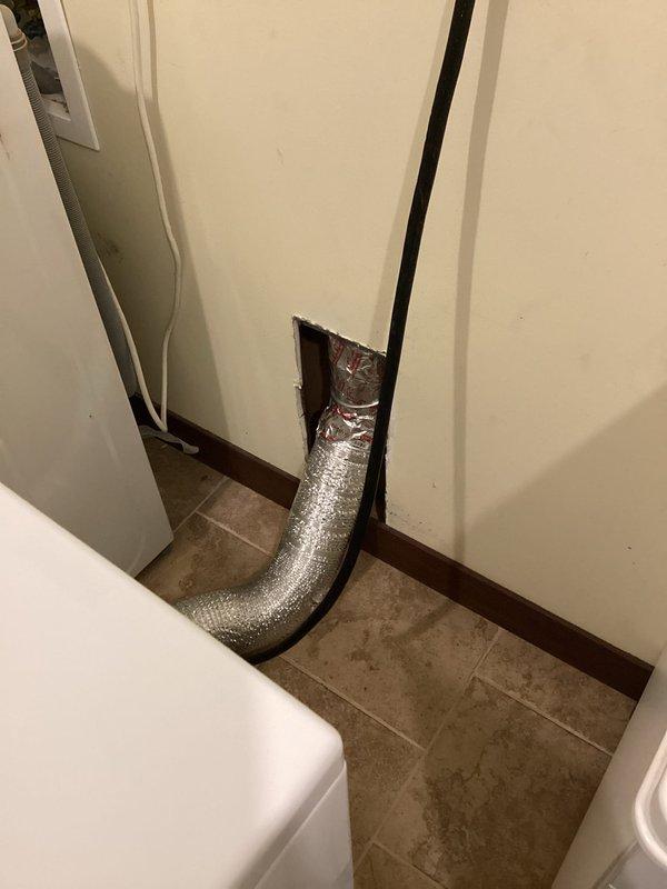 Responded to service call regarding a disconnecting dryer vent. Upon inspection, determined the wall vent pipe was insufficient in length to properly connect through the access panel. Extended the dryer vent duct at a 45-degree angle to ensure secure connection and proper ventilation.