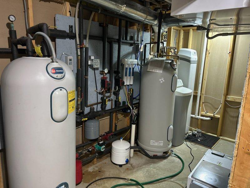 Performed comprehensive geothermal system inspection for property under contract for purchase. System was thoroughly examined including ductwork, water heater components, expansion tank, and associated plumbing infrastructure in basement utility area. All equipment found to be in proper working condition with no issues identified that would require immediate attention or repair.