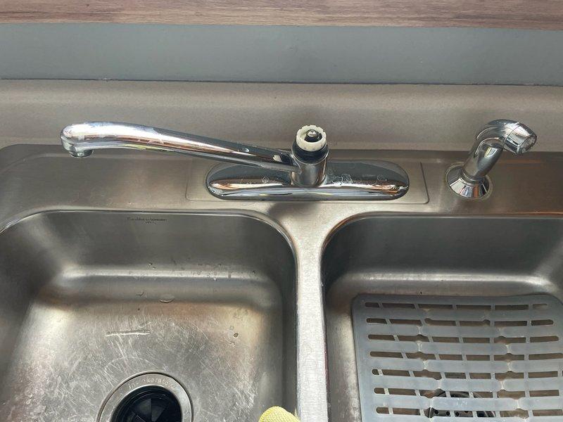 Removed existing kitchen faucet and successfully installed customer-supplied Moen kitchen faucet in stainless steel double-basin sink. Completed all necessary water connections, tested operation, and verified proper functionality with no leaks.