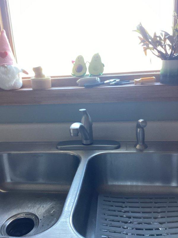 Removed existing kitchen faucet and successfully installed customer-supplied Moen kitchen faucet in stainless steel double-basin sink. Completed all necessary water connections, tested operation, and verified proper functionality with no leaks.