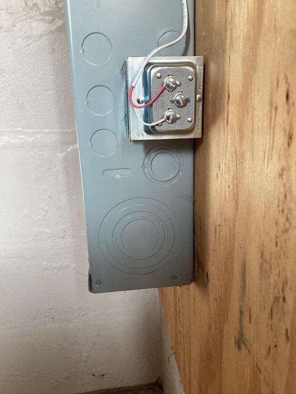 Installed new outlet in garage for automatic door opener by extending wiring from existing switch box to opener location. Replaced exposed doorbell transformer and secured proper connections, eliminating safety hazard of exposed wires. Rewired transfer to ensure proper electrical function and code compliance.