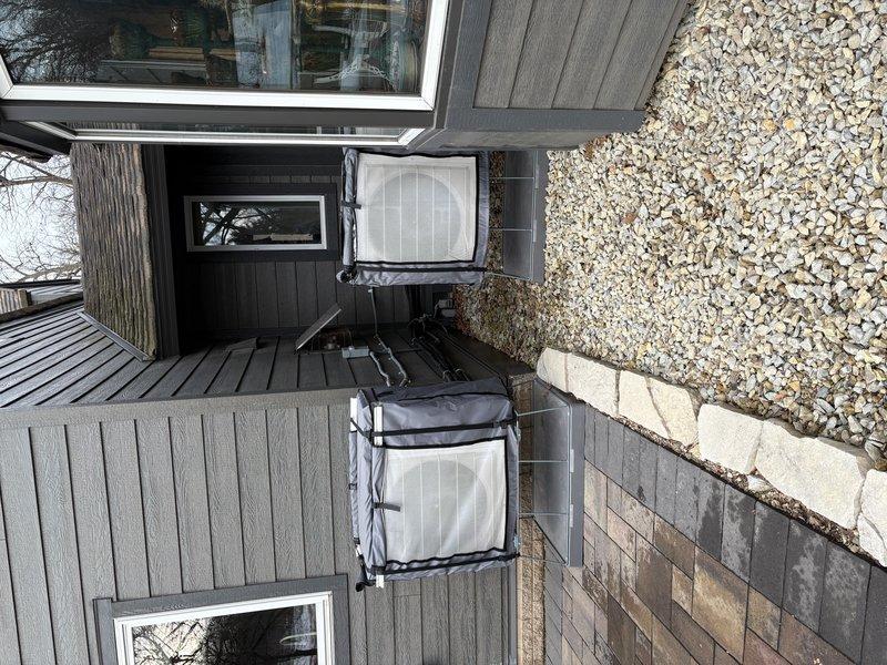 Performed scheduled mini-split system tune-up on two outdoor condenser units per maintenance agreement. Units were properly installed on concrete pad with adequate clearance and appropriate weatherproof covers. Service included comprehensive preventative maintenance according to manufacturer specifications.