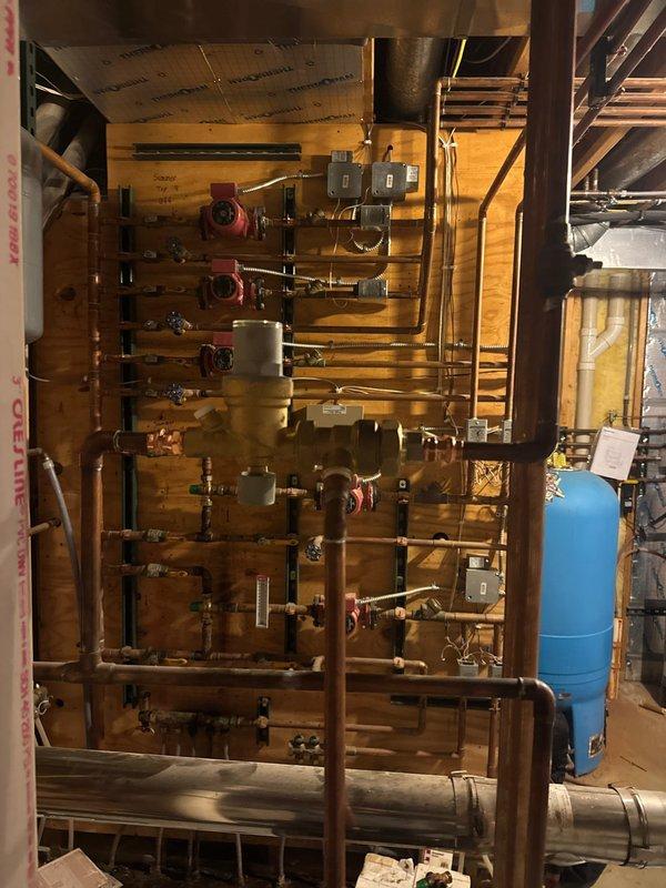 Successfully installed mixing valve and auto fill on boiler system, configured to maintain 15 psi operating pressure. Completed comprehensive installation of copper piping with multiple control valves on the distribution manifold, ensuring proper integration with the existing expansion tank.