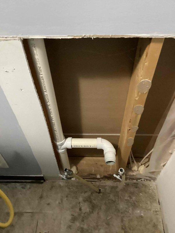 Completed inspection of a sink venting issue, requiring wall access to examine existing plumbing configuration. Verified the need for a new vent pipe installation for the downstairs sink per previous inspection requirements. Documented the exposed wall cavity showing PVC piping and structural elements with photos for reference. Provided customer with estimate for installing proper venting solution, which will require inspector verification upon completion.