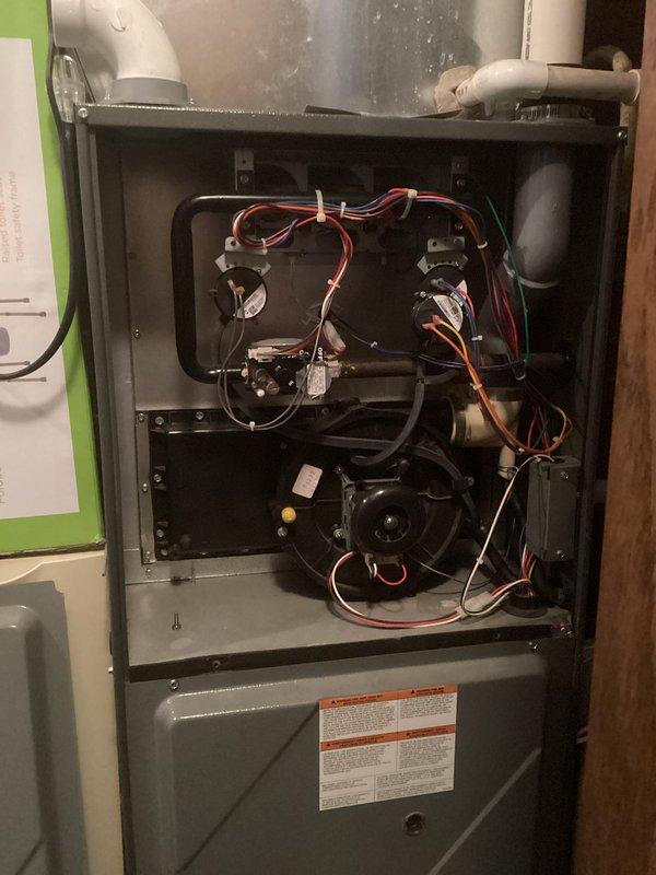 Diagnosed no heat condition in customer's furnace, revealing a failed heat exchanger during inspection. Documented system condition with photos showing internal components and connected PVC venting. Presented options for heat exchanger replacement or complete system replacement to restore heating functionality.